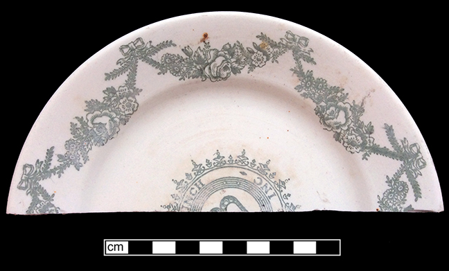 Plate, similar to example shown from diner named “Baltimore Dairy Lunch”. Unglazed bisque waster. Transfer printed in dark green. Rim diameter: 6.75”; 4.1 mm thick. Impressed mark on reverse:Maddock’s ….n [Trenton] China.